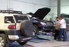 Vehicles being repaired in the D & S Body Shop repair bay